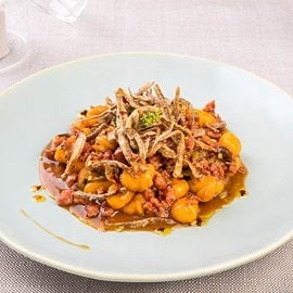 Gnocchetti di patate con ragù di capretto, funghetti chiodini, fiammiferi di cardi croccanti ed olio di peperone crusco Gnocchetti di patate con ragù di capretto, funghetti chiodini, fiammiferi di cardi croccanti ed olio di peperone crusco