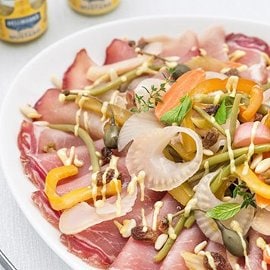 Lombo di maiale con verdure in carpione, capperi, uvetta e pinoli Lombo di maiale con verdure in carpione, capperi, uvetta e pinoli