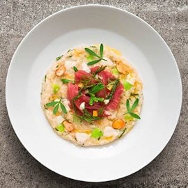 Risotto mantecato al latte di mandorla affumicato, limone candito, carpaccio di tonno rosso e salicornia Risotto mantecato al latte di mandorla affumicato, limone candito, carpaccio di tonno rosso e salicornia