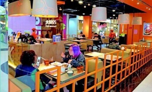 Social Distancing: One empty table between each diner in quick service restaurant Social Distancing: One empty table between each diner in quick service restaurant